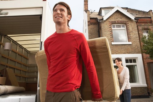 Removal staff loading commercial furniture for a Hillingdon relocation