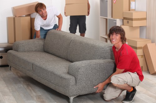 Mover wearing PPE while handling furniture safely